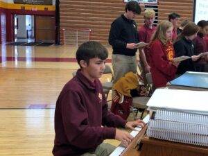 Anthony Higgins plays the piano at a Scecina school Mass.